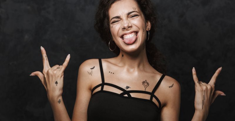 excited woman sticking out her tongue and gesturing horns